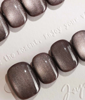 Fume handmade press-on nails featuring taupe brown cat eye