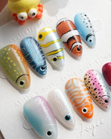 Funky Fish short almond nails with colorful reef fish, stripes, scales, and 3D eyes