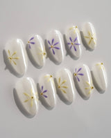 Garden Party press-on nails in short almond shape — minimal floral french tip