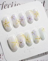 Garden Party press-on nails in short oval shape — minimal floral french tip