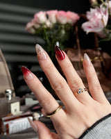 Gilded Rouge short almond press-ons with rich amber red color and raised gold details