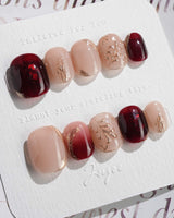 Gilded Rouge in extra short squoval shape with burgundy color and embossed gold leaf