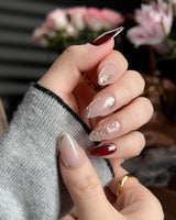 Gilded Rouge press-on nails with burgundy amber color and embossed gold leaf accents
