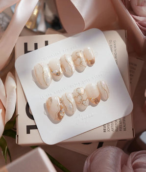 Gilded Truth handmade press-on nails featuring Minimalist Aurora White, Gold Metallic Outlines & Heart Illustrations.