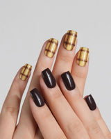 Close-up of Ginger Plaid nails with dark brown polish and lemon yellow plaid pattern
