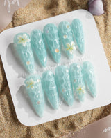 Glass Sea long stiletto nails with ocean wave shimmer and sculpted flowers