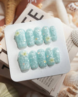 Glass Sea medium square nails with mint blue waves and glossy pearl details
