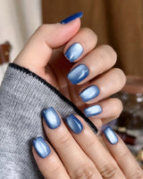 Glass Sky nail art close-up showing deep ocean blue cat eye details