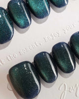 Glint Aurora press-on nail set — deep teal cat eye shimmer design, hand-painted with real gel polish