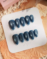 Glint Midnight nail art close-up showing deep teal cat eye shimmer details