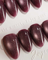 Glint Plum press-on nail set — deep plum cat eye shimmer design, hand-painted with real gel polish