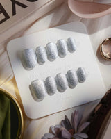 Glitter Frost press-on nails in extra short oval shape — silver glitter