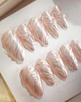 Velvet Twist nail art close-up showing Pink silver chrome swirl 3D sculpted glitter overlay details