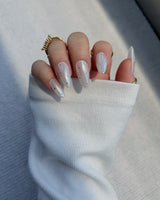 Glitz Galore nail art close-up showing milky white rhinestone nails details