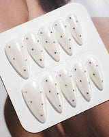 Glitz Galore press-on nails in medium stiletto shape — milky white rhinestone nails