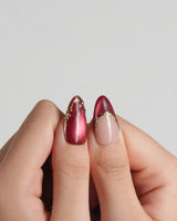 Lily Rouge press-on nails with glossy red cat-eye effect and raised floral accents