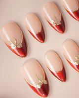 Bow French nail art close-up showing nude base red chrome french gold outline bow accent details