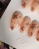 Glow Petals handmade press-on nails featuring Gentle Nude Pink, Rose Gold Flowers & Gold Flakes.
