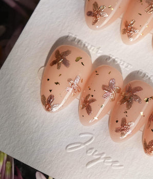Glow Petals handmade press-on nails featuring Gentle Nude Pink, Rose Gold Flowers & Gold Flakes.