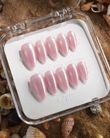 Glow Pop pearl pink nude nails with reflective chrome powder and glowing cat-eye finish