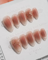 Glowing Blush press-on nails — Transparent Blush Cat Eye, Simple Silver Bow Outline. handmade nail art by Joyee Nails
