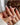 Romantic nude French nails with metallic bow detail