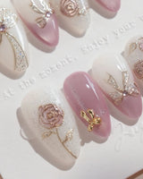 Golden Hour nail art close-up showing Romantic Dusty Pink Gradient, 3D Metallic Roses & Silver Ribbon. details