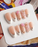 Golden Tide elegant press-on nails with pink and gold flowers on nude white French base