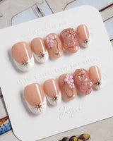 Golden Tide gold French tip floral press-on nails in short oval shape