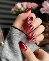 Gone with the Wind press-on nails in short almond shape — Marbled Burgundy, Gold Foil Accents.