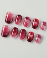 Gone with the Wind extra short oval press-on nails with burgundy marble and gold foil accents