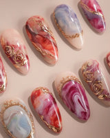 Baroque Palette press-on nails with red and pink marble mix, blue swirls and gold trim