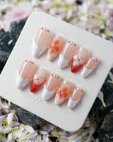Duchess Marigold handmade nails with sculpted marigold orange flowers and nude French base