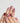 Holiday press-on nails with hand-painted bows and candy stripes