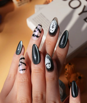 Cat Sitter press on nails with a long-tailed black cat, a row of bats and a white ghost holding a kitten on black and nude with pink shimmer - image 1