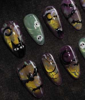 Fright Night press on nails with a fanged black cat, bats, white skulls and spider webs on purple gold and green cat eye - image 1