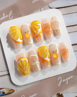 Juicy Juicy close-up of translucent orange press-on nails with fruit texture