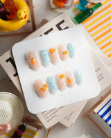 Juicy Summer citrus press-on nails with orange fruit charms and fizzy polka dots