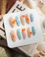Juicy Summer orange citrus press-on nails in medium almond shape
