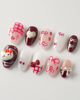 KT Cake press-on nails in extra short almond with cute cake accents and gel finish