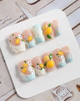Lemon Shore handmade summer nails with aqua blue accents and lemon blossoms