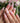 Hand-sculpted lily nail art in soft pink tones