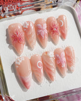 Lily-Nocturne press-on nails in medium stiletto shape — Soft Peach Pink, 3D Lilies & Shell Textures.