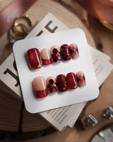 Lily Rouge short square press-on nails with red cat-eye French tips and floral details
