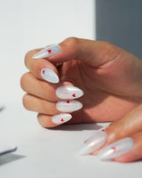 Little Luck handmade press-on nails featuring milky white red heart nails