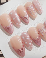 Love Letter handmade press-on nails featuring Dreamy Shimmer Pink, 3D Metallic Bows, White Hearts & Hand-painted Ribbons.