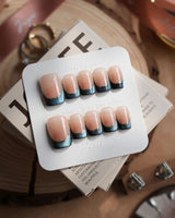 Malta Blue short square nails with navy cat-eye French tips and nude base