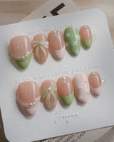 Matcha Ribbon press-on nails in extra short almond shape — Fresh Jelly Green, 3D Bows & French Pearl Outlines.