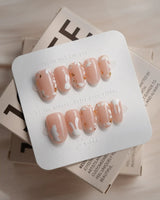 Meadow Bunny nail art close-up showing nude,Hand-painted White Bunnies & Gold Foil Floral Accents details