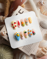 Mercato maximalist 3D press-on nails in butter yellow, pistachio, blue, and blush